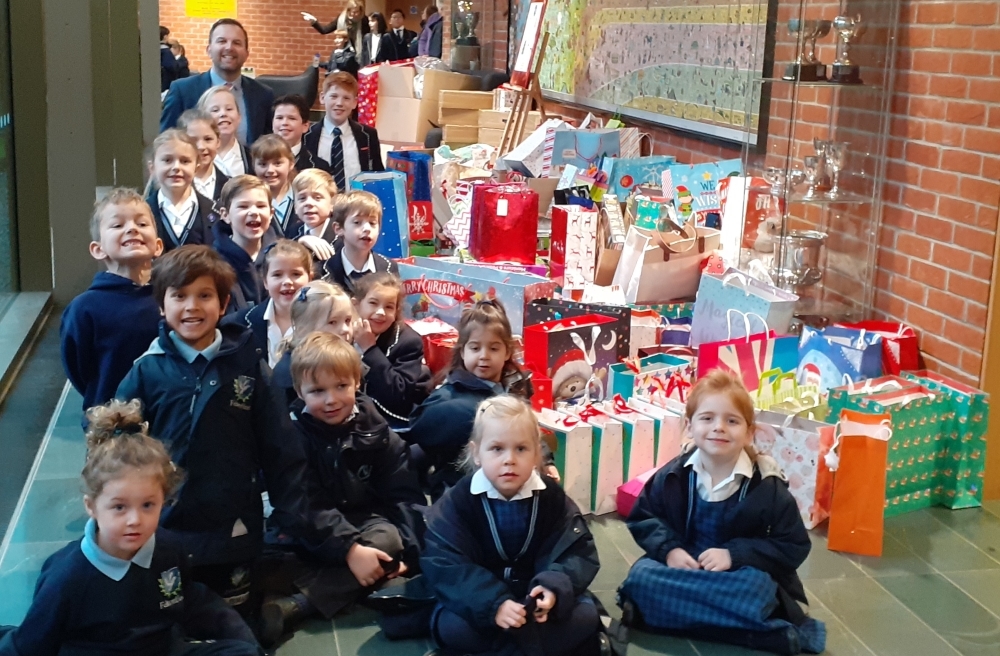 Feltonfleet pupils and Deputy Head, Mr Carradine, with gifts donated by Feltonfleet parents for Oasis charity (web)